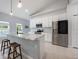 Modern kitchen featuring white cabinets, stainless steel appliances, and a marble island at 141 W Main St, Lake Helen, FL 32744