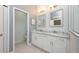 Bright main bathroom featuring a double vanity, marble countertops, and modern lighting at 141 W Main St, Lake Helen, FL 32744