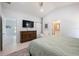 Spacious main bedroom with ensuite bathroom and a large dresser with wall mounted television at 141 W Main St, Lake Helen, FL 32744