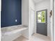 Mud room with a gray door, blue accent wall, and built in marble countertop area at 141 W Main St, Lake Helen, FL 32744