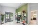 Bright office space with french doors to patio, stylish bookshelves and an accent wall at 141 W Main St, Lake Helen, FL 32744