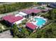 Community center aerial showing the pool, clubhouse, and amenities nestled among trees and homes at 14366 Alafaya Oak Bnd, Orlando, FL 32828