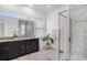 The main bathroom has a granite topped double sink vanity, a tiled shower, and a window at 14366 Alafaya Oak Bnd, Orlando, FL 32828
