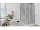 This bathroom has a granite topped vanity, a glass enclosed shower, gray tile, and a decorative potted plant at 14366 Alafaya Oak Bnd, Orlando, FL 32828