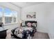This bedroom has a window and features light gray carpeting, a black leather headboard, and a floral patterned bedspread at 14366 Alafaya Oak Bnd, Orlando, FL 32828