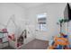 This bedroom has light gray carpeting, a window, and features a play tent and other toys at 14366 Alafaya Oak Bnd, Orlando, FL 32828