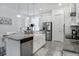 Bright kitchen featuring stainless steel appliances, a farmhouse sink, and a granite countertop island at 14366 Alafaya Oak Bnd, Orlando, FL 32828