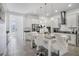 Modern kitchen with white cabinetry, granite countertops, a large island and stainless steel appliances at 14366 Alafaya Oak Bnd, Orlando, FL 32828