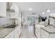 Contemporary kitchen with white cabinets, granite countertops, and stainless steel appliances overlooking the dining area at 14366 Alafaya Oak Bnd, Orlando, FL 32828