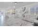 Open-concept living room connecting to a modern kitchen with granite countertops and stainless appliances at 14366 Alafaya Oak Bnd, Orlando, FL 32828