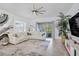Open-concept living room with a large sectional sofa, modern decor, and ample natural light at 14366 Alafaya Oak Bnd, Orlando, FL 32828