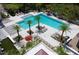 An aerial view of a community pool surrounded by lounge chairs and lush landscaping at 14366 Alafaya Oak Bnd, Orlando, FL 32828