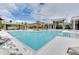 A large community pool with lounge chairs and covered seating areas, perfect for relaxation at 14366 Alafaya Oak Bnd, Orlando, FL 32828
