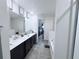 Bathroom suite featuring a dual vanity, soaking tub, and a private commode at 1713 Redfin Way, Kissimmee, FL 34759