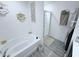 Clean bathroom featuring a soaking tub, glass-enclosed shower, and modern fixtures at 1713 Redfin Way, Kissimmee, FL 34759