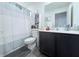 Neat bathroom with a shower-tub combination, cabinet for towels, and a mirror at 1713 Redfin Way, Kissimmee, FL 34759