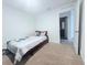 Bright bedroom with neutral carpet, white walls, and a partial view of an ensuite bathroom at 1713 Redfin Way, Kissimmee, FL 34759
