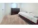 Bedroom featuring a dark wood dresser, carpet, and a white comforter with blue accents at 1713 Redfin Way, Kissimmee, FL 34759