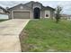 Charming one-story home featuring a two car garage, neutral stucco and a well-maintained front lawn at 1713 Redfin Way, Kissimmee, FL 34759