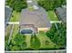 Aerial view of a backyard with a screened-in pool, lush landscaping, and a fenced perimeter at 1862 Lorenzo Ln, Oviedo, FL 32765