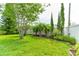 Lush backyard with healthy green grass, flower beds and a privacy fence at 1862 Lorenzo Ln, Oviedo, FL 32765