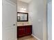 Bathroom featuring vanity, sink, framed mirror, and accent lights at 1862 Lorenzo Ln, Oviedo, FL 32765
