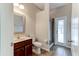 Bathroom featuring granite countertops, wood cabinetry, and a stand up shower at 1862 Lorenzo Ln, Oviedo, FL 32765