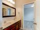 Bright bathroom featuring a double vanity with granite countertops and access to the bedroom at 1862 Lorenzo Ln, Oviedo, FL 32765