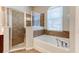 Bathroom featuring a glass shower, soaking tub, and tile surround at 1862 Lorenzo Ln, Oviedo, FL 32765
