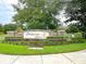 Chapman Cove community sign surrounded by mature landscaping and green grass at 1862 Lorenzo Ln, Oviedo, FL 32765