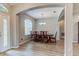 Formal dining room featuring a modern chandelier, wood flooring, and natural lighting at 1862 Lorenzo Ln, Oviedo, FL 32765