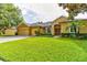 Charming single-Gathering home featuring a manicured front yard, brick driveway, and a spacious three-car garage at 1862 Lorenzo Ln, Oviedo, FL 32765