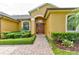 Welcoming front entrance featuring a brick pathway, lush landscaping, and a classic wooden door at 1862 Lorenzo Ln, Oviedo, FL 32765