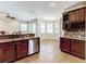 Open kitchen featuring stainless dishwasher with tile floors extending to dining and living area at 1862 Lorenzo Ln, Oviedo, FL 32765