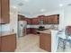 Beautiful kitchen featuring stainless steel appliances, granite countertops, tile backsplash, and ample cabinet space at 1862 Lorenzo Ln, Oviedo, FL 32765