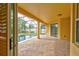 Covered patio featuring brick flooring, a ceiling, and a view of the pool at 1862 Lorenzo Ln, Oviedo, FL 32765