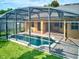 Backyard view featuring a screened-in pool, brick patio, and well-maintained lawn at 1862 Lorenzo Ln, Oviedo, FL 32765