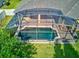 Aerial view of the screened-in pool and covered patio, perfect for outdoor entertaining at 1862 Lorenzo Ln, Oviedo, FL 32765