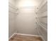 Spacious walk-in closet features wire shelving and wood-look flooring at 1862 Lorenzo Ln, Oviedo, FL 32765