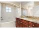 Bathroom featuring granite countertops, wood cabinets, and a shower and tub combination at 191 Villa Di Este Ter # 201, Lake Mary, FL 32746