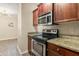 Updated kitchen showcasing granite countertops and stainless steel appliances at 191 Villa Di Este Ter # 201, Lake Mary, FL 32746