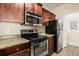 Close-up of a kitchen with stainless steel appliances and granite countertops at 191 Villa Di Este Ter # 201, Lake Mary, FL 32746