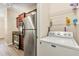 Laundry and kitchen area featuring stainless steel appliances and a washer at 191 Villa Di Este Ter # 201, Lake Mary, FL 32746