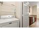 Laundry area with shelving and washer at 191 Villa Di Este Ter # 201, Lake Mary, FL 32746