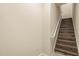 Interior stairs with wood-look steps and a white handrail at 191 Villa Di Este Ter # 201, Lake Mary, FL 32746