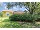 Backyard featuring a patio, lush greenery, and mature landscaping all around the home at 1910 Palm View Dr, Apopka, FL 32712