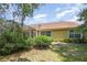 Backyard featuring a patio, lush greenery, and mature landscaping all around the home at 1910 Palm View Dr, Apopka, FL 32712