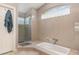 Bathroom with a shower, large soaking tub and big windows at 1910 Palm View Dr, Apopka, FL 32712