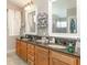 Bathroom featuring a double vanity with granite countertops, and a large framed mirror at 1910 Palm View Dr, Apopka, FL 32712