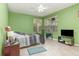 Cozy bedroom featuring tile floors, a ceiling fan, and bright natural light from the exterior windows at 1910 Palm View Dr, Apopka, FL 32712